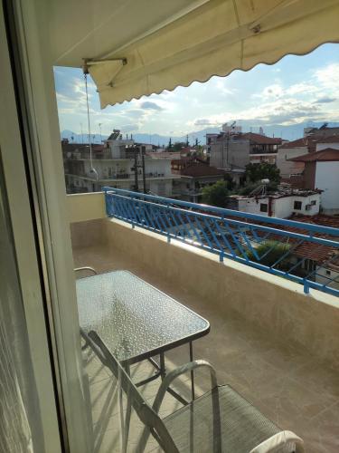 a table and chair on a balcony with a view at GCM 1 ROOMS kentro k parking in Katerini