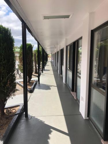 an empty hallway of a building with windows at Jackie Howe Motel in Warwick