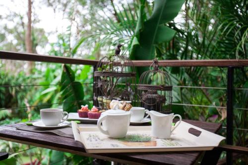 a table with two cups and a tray of food at Mt Cotton Retreat in Mount Cotton