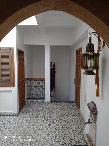 an entry way with a tile floor and a chandelier at Riad Dar Badiaa in Sale