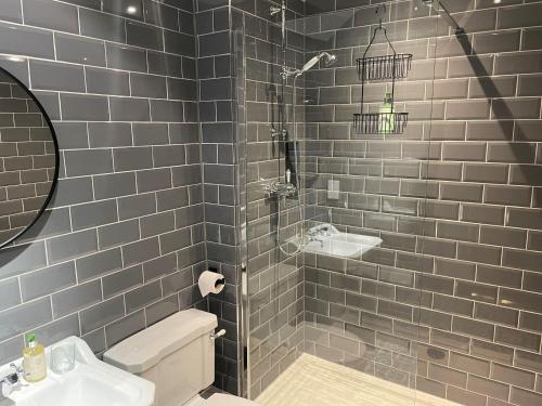 a bathroom with a shower and a sink and a toilet at The Chequers Inn in Froggatt