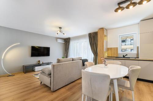 a living room with a couch and a table at Balance Apartments Complex Qualis Brasov in Braşov