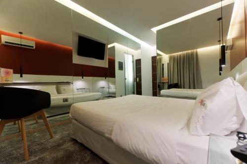 a hotel room with a large bed and a television at X Dream Hotel-Adults Only in Athens