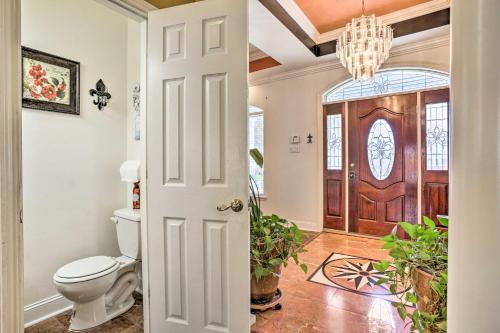 a bathroom with a toilet and a door with a chandelier at Welcoming New Orleans Home Near Bourbon St! in New Orleans