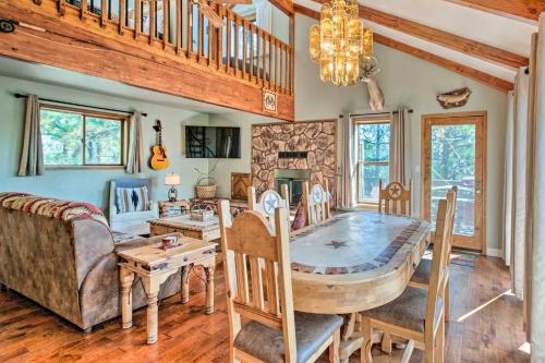 a dining room and living room with a wooden table at Hot Tub, Game Room Spacious Angel Fire Retreat! in Angel Fire