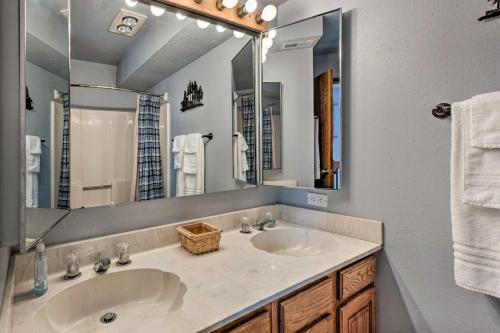 a bathroom with two sinks and a large mirror at Hot Tub, Game Room Spacious Angel Fire Retreat! in Angel Fire