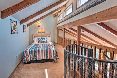 a bedroom with a bed in a room with wooden ceilings at Hot Tub, Game Room Spacious Angel Fire Retreat! in Angel Fire