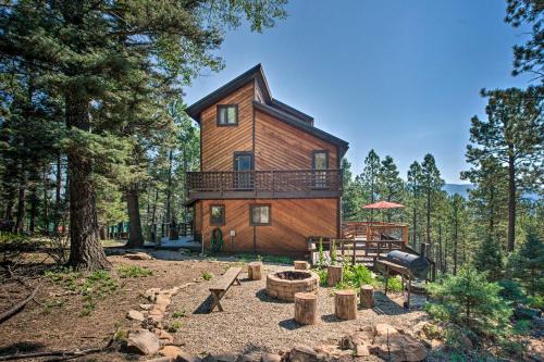 a tree house in the woods with a patio at Hot Tub, Game Room Spacious Angel Fire Retreat! in Angel Fire