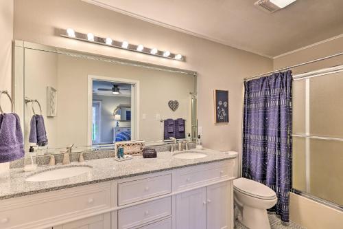 a bathroom with two sinks and a toilet and a mirror at Fantastic Hot Springs Condo Hot Tub Access! in Hot Springs