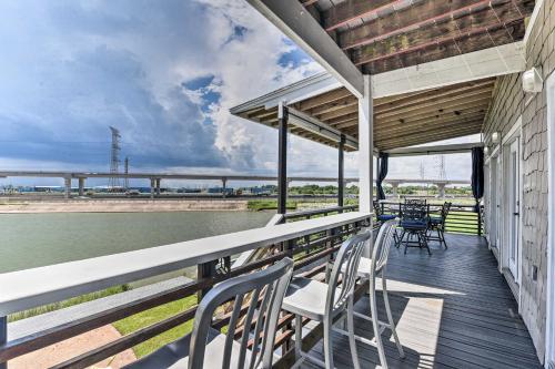 a porch with chairs and tables on the water at Secluded Seabrook Waterfront Home with Patio! in Seabrook