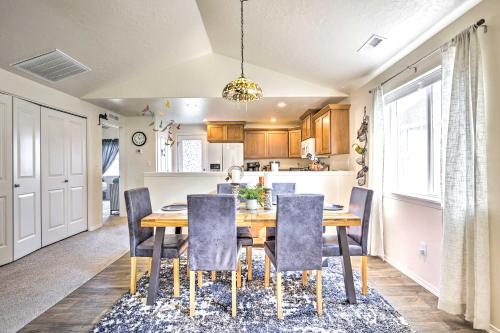 a kitchen and dining room with a wooden table and chairs at Prismatic Boise Retreat with Fenced Backyard! in Boise