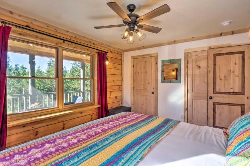 a bedroom with a bed with a ceiling fan and a window at 24-0132 Alma Retreat with Deck 17 Mi to Skiing in Fairplay