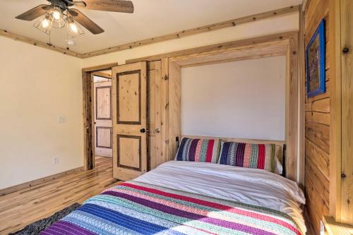 a bedroom with a bed and a ceiling fan at 24-0132 Alma Retreat with Deck 17 Mi to Skiing in Fairplay
