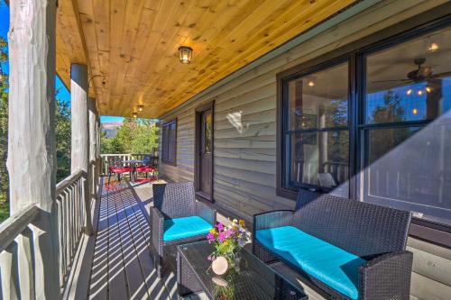 a porch with two chairs and a wooden ceiling at 24-0132 Alma Retreat with Deck 17 Mi to Skiing in Fairplay