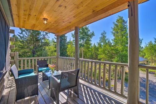 a patio with chairs and a table on a deck at 24-0132 Alma Retreat with Deck 17 Mi to Skiing in Fairplay