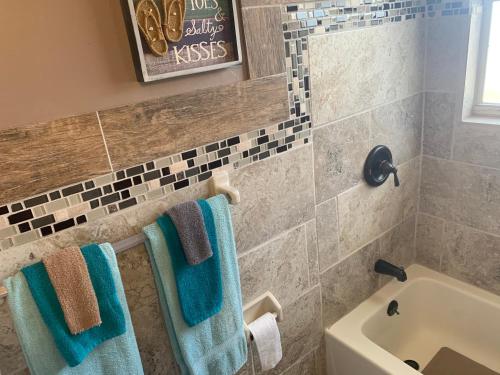 La salle de bains est pourvue de serviettes bleues et d'un lavabo. dans l'établissement Michaels Siesta Studios, à Redington Shores