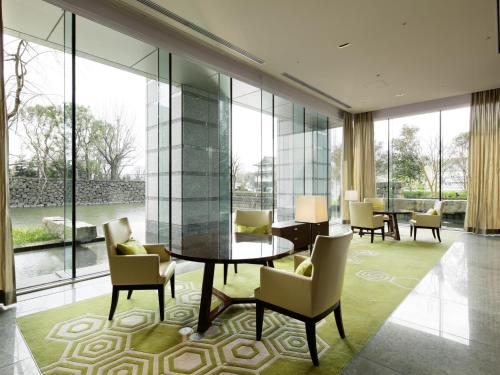 a living room with chairs and tables in it at Palace Hotel Tokyo in Tokyo