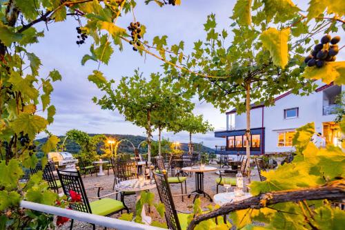 a view of a patio with tables and chairs at Waldhotel Sonnenberg in Bollendorf