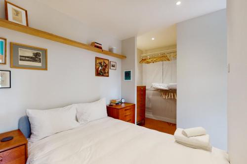 a bedroom with a white bed and a closet at Spacious 1 bedroom apartment in Kennington in London