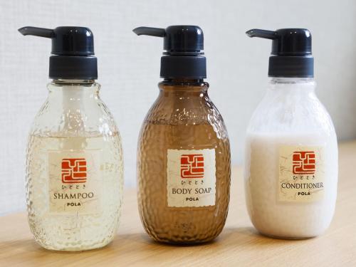 three bottles of soy sauce sitting on a table at Plum Hotel in Osaka