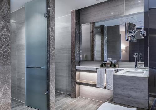 a bathroom with a sink and a mirror at Rixos Premium Belek - The Land of Legends Access in Belek