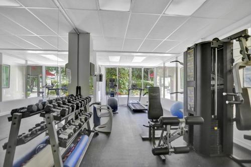 a gym with a lot of treadmills and machines at Mantell Plaza Apartments in Miami Beach