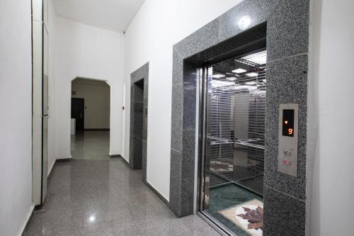 a hallway with a glass door in a building at Leyla Apartments 2 in Baku