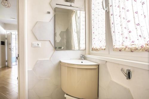 a bathroom with a toilet and a sink and a mirror at RomaDamare in Passoscuro