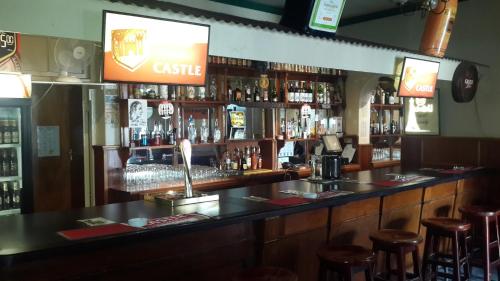 a bar with a lot of bottles of alcohol at Victoria Hotel in Bredasdorp