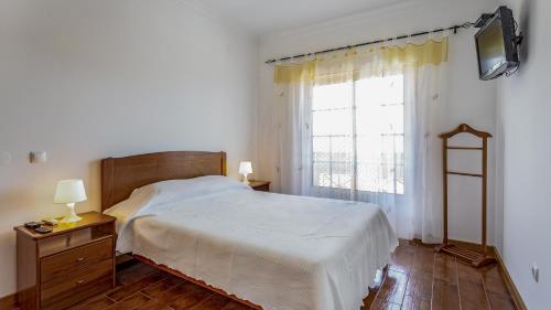 a bedroom with a bed and a large window at Wonderful Algarvinian Home by LovelyStay in Vila Nova de Cacela