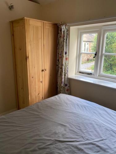 a bedroom with a bed and a window at The Grange in Bristol