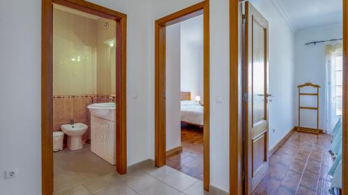 a bathroom with a sink and a toilet in a room at Wonderful Algarvinian Home by LovelyStay in Vila Nova de Cacela