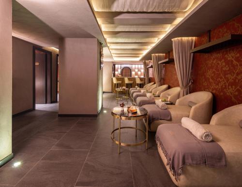 a room with a row of couches and a table at Cronton Design Hotel in Istanbul