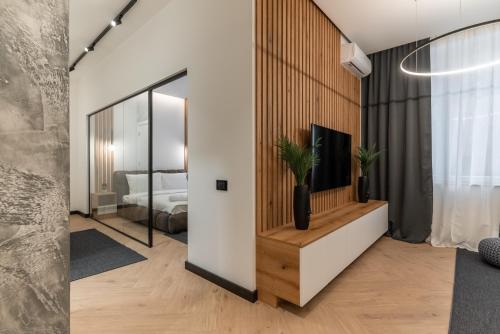a living room with a tv and a bedroom at Silver Luxury Suites in Belgrade