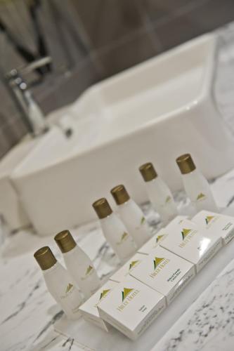a bunch of wine bottles on a counter next to a sink at Hilly Hotel in Edirne