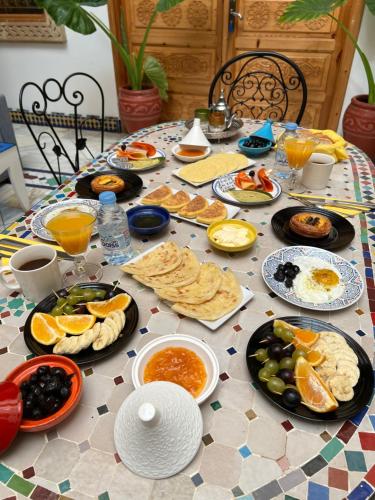 a table full of breakfast foods and drinks at Dar Rehab in Rabat