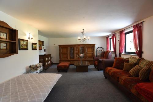 a living room with a bed and a couch at LakeView Apartment in Preddvor