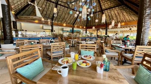 a dining room with a table with plates of food at Canto del Sol Puerto Vallarta All Inclusive in Puerto Vallarta