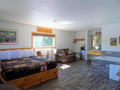 a hotel room with a bed and a bath tub at Eagle's Nest Motel in Priest River