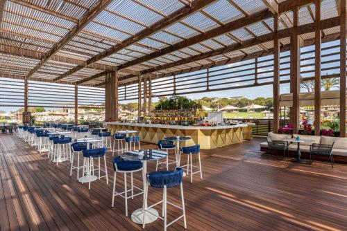 a large room with tables and chairs and a bar at Rixos Premium Belek - The Land of Legends Access in Belek