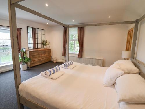a bedroom with a large bed with two pillows on it at Hall Farm in Market Rasen