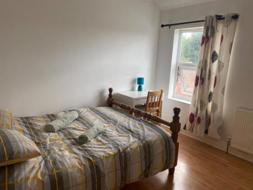 a bedroom with a bed and a window at 160 Exning Road in Newmarket