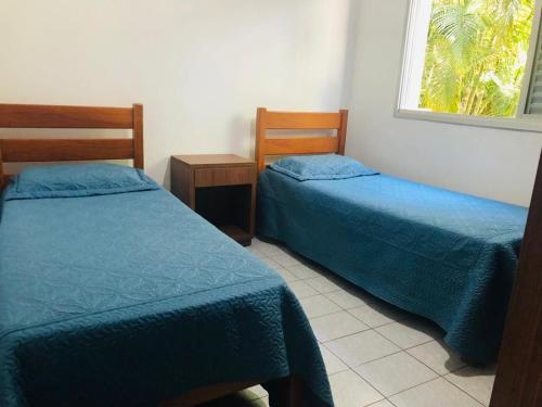 מיטה או מיטות בחדר ב-Apartamento com 3 quartos em Itagua