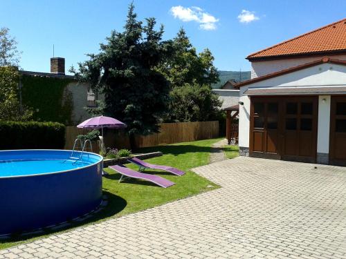 a backyard with a hot tub and an umbrella at Vila Caba in Křemže