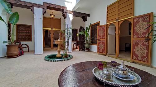 a room with a wooden table and a room with at RIAD DAR En-Nawat in Marrakesh