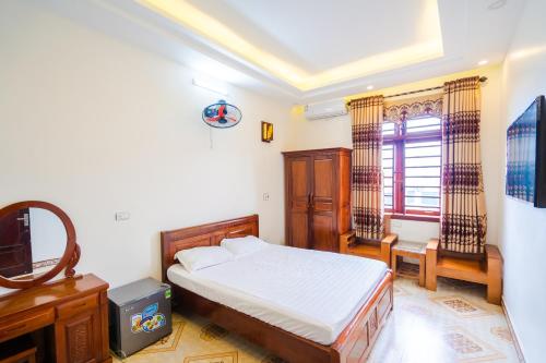 a bedroom with a bed and a television in it at Nhà Nghỉ Xuân Mai in Lạng Sơn