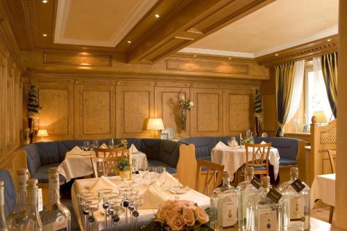 a dining room with tables and chairs and bottles at Hotel-Restaurant Schwanen in Weil am Rhein