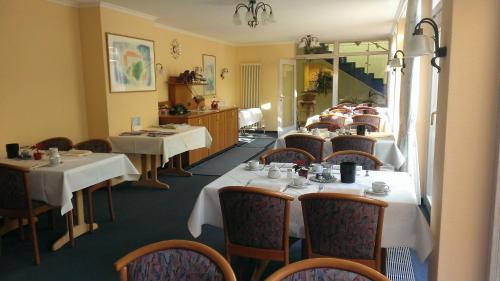 a dining room with white tables and chairs at Hotel-Restaurant Schwanen in Weil am Rhein