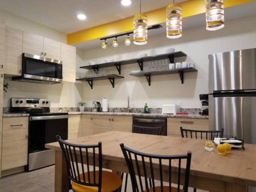 a large kitchen with a wooden table and chairs at Super Close to Hot Spots in Ohio City, Cleveland in Cleveland