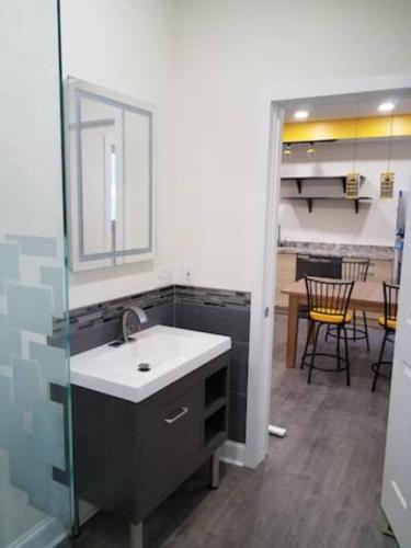 a kitchen with a sink and a table with chairs at Super Close to Hot Spots in Ohio City, Cleveland in Cleveland